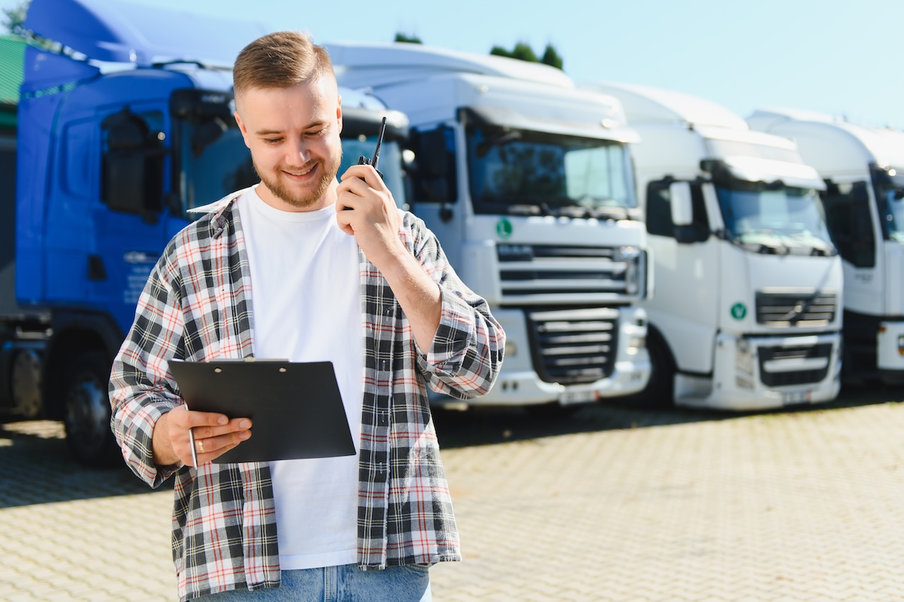 employee in front of fleet parking in storage facility
